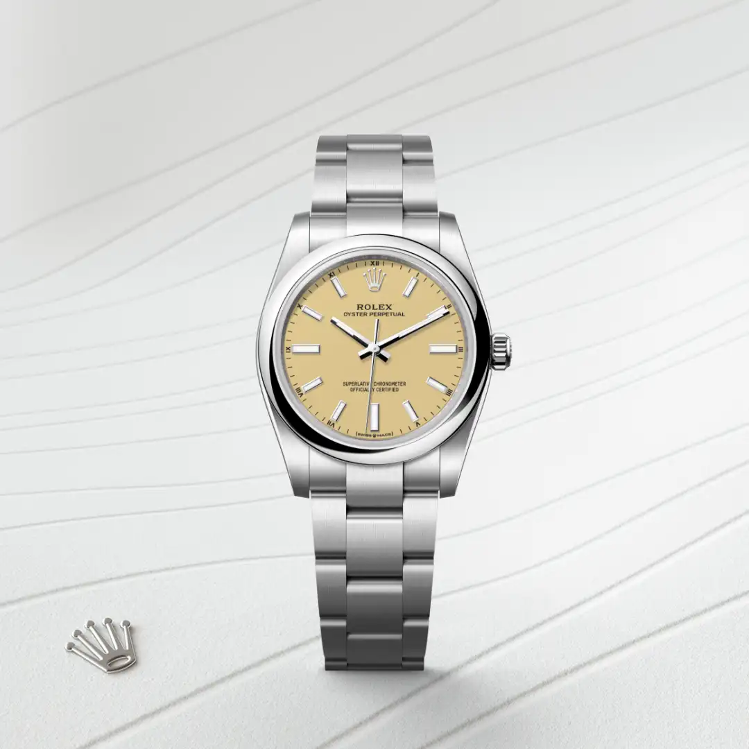 m124200-0007-slide1 | Brela Silver Rolex Oyster Perpetual wristwatch with a beige dial and stainless steel bracelet displayed on a light, lined surface. | Brela