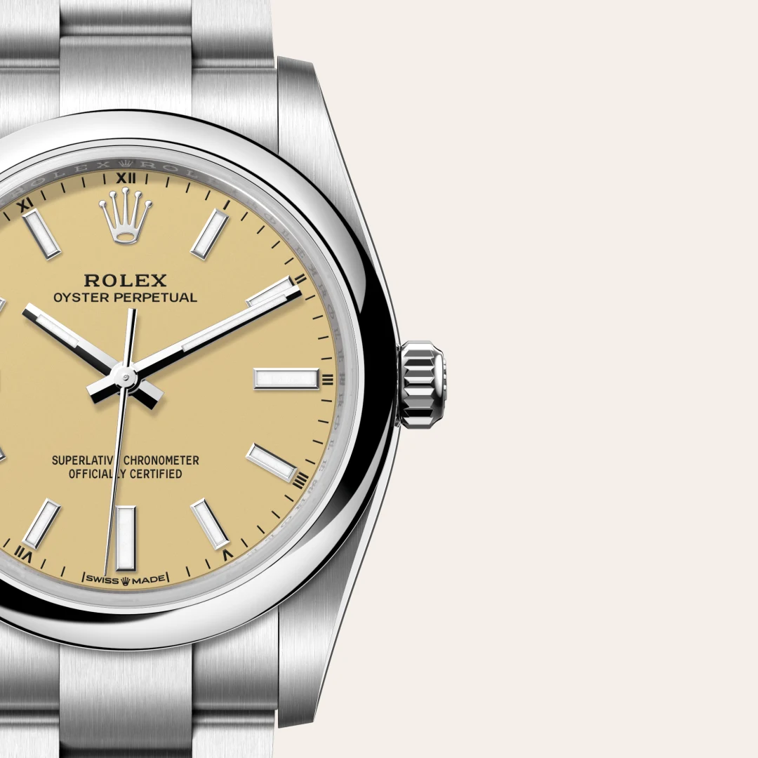 m124200-0007-slide3 | Brela Close-up of a Rolex Oyster Perpetual wristwatch with a beige dial and brushed steel bracelet, crown visible. | Brela