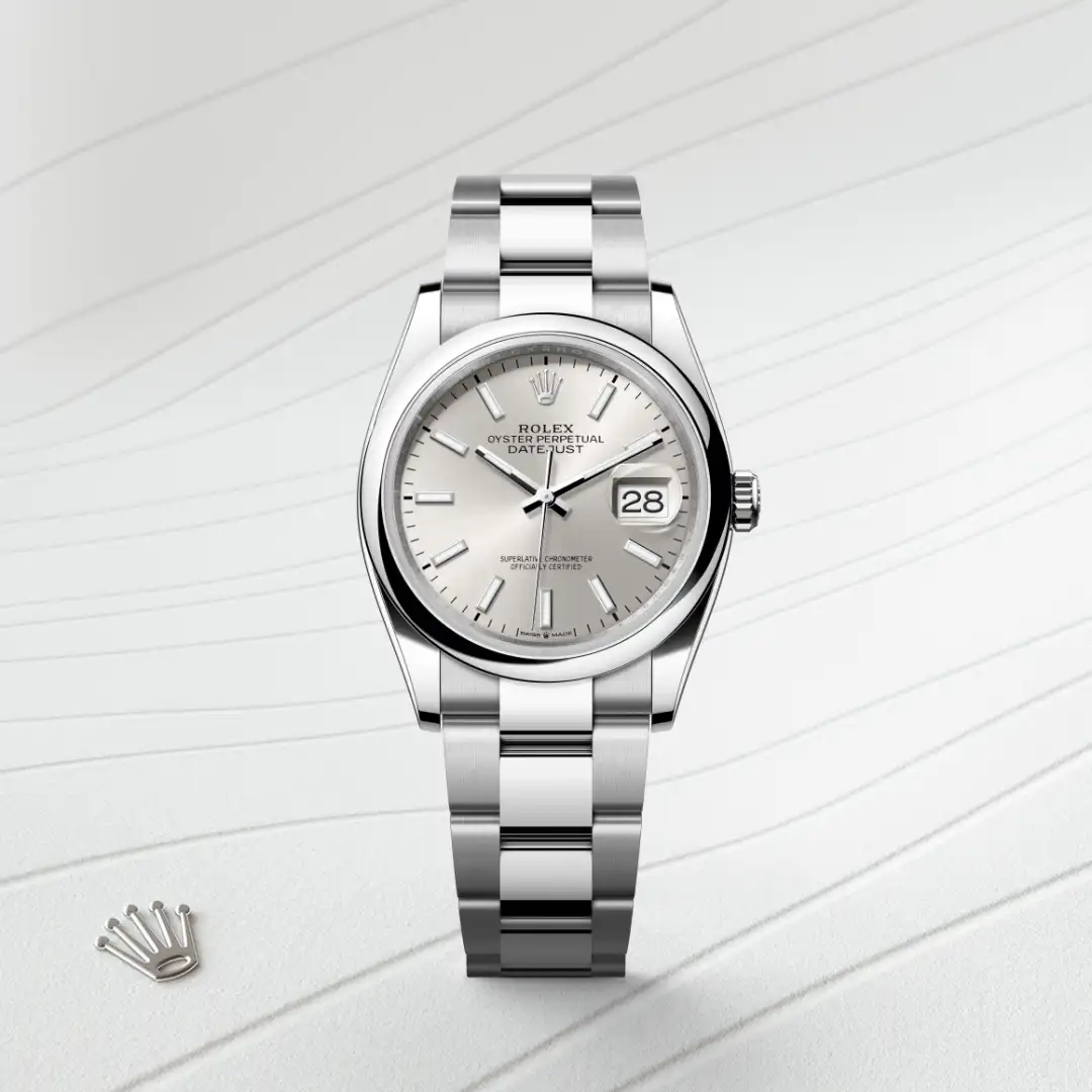 Stainless steel Rolex Datejust wristwatch with silver dial and date window at 3 o'clock on a light striped background. | Brela