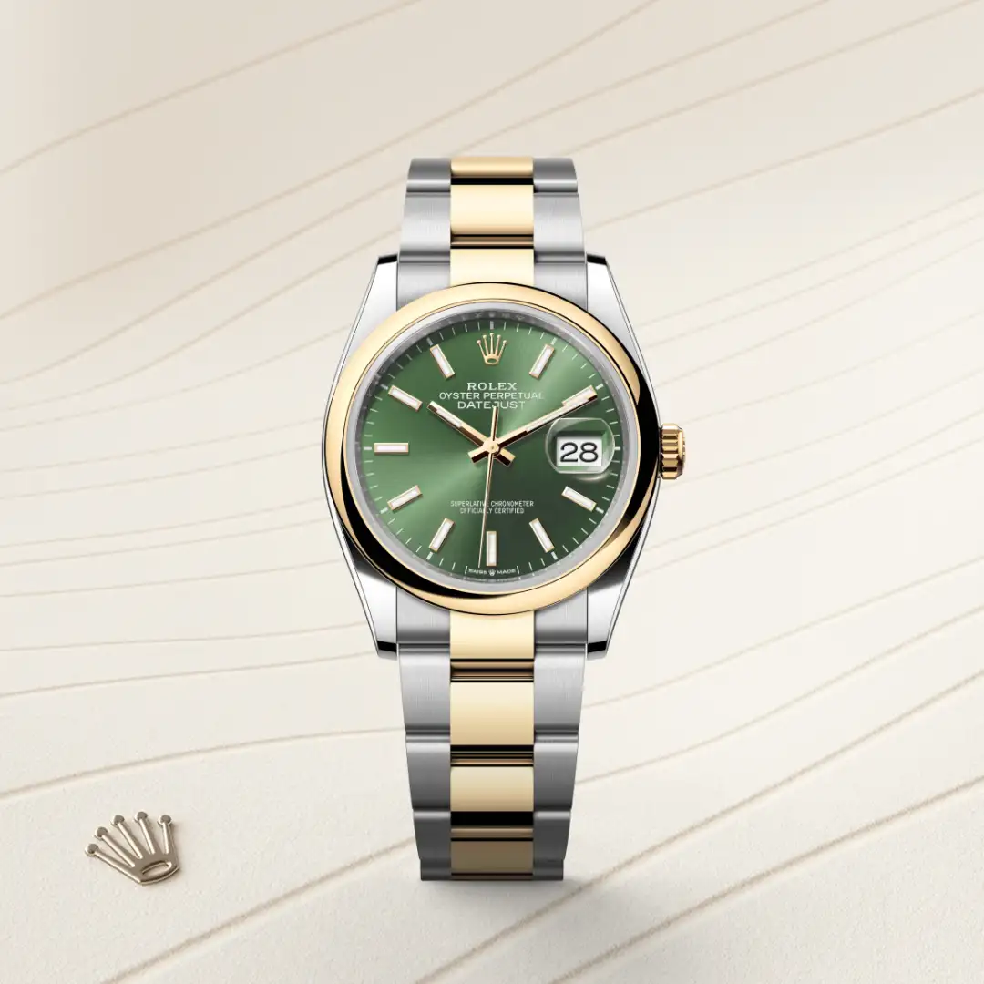 Rolex Datejust wristwatch with a green dial, two-tone gold and stainless steel bracelet, and date window at 3 o'clock. | Brela