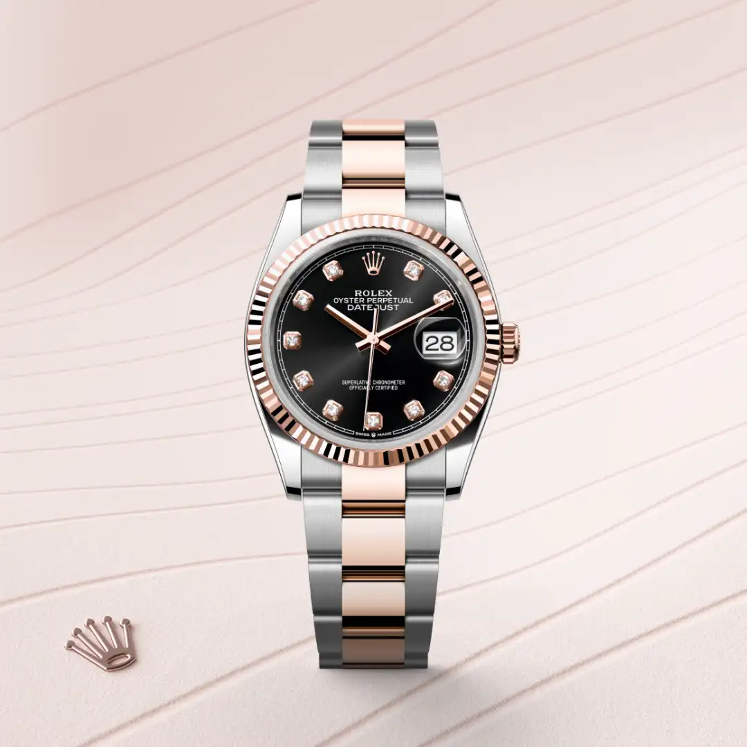 Two-tone Rolex Datejust with black dial, diamond hour markers, and rose-gold fluted bezel on a two-tone bracelet. | Brela