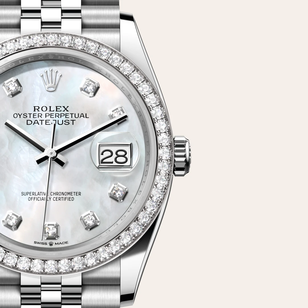 m126284rbr-0011-slide3 | Brela Close-up of a Rolex Oyster Perpetual Datejust watch with a diamond-studded bezel, pearl dial, and date window showing 28. | Brela