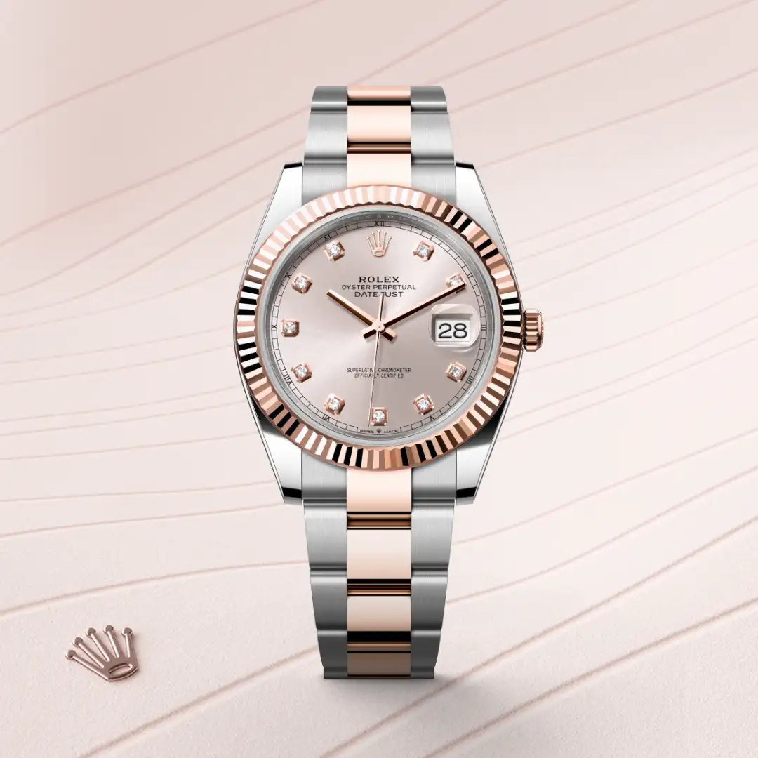 m126331-0007-slide1 | Brela Rolex Datejust with rose-gold fluted bezel, steel and rose bracelet, diamond hour markers, and date display at 3 o'clock on a pink dial. | Brela