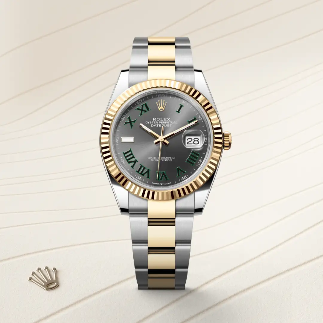 Two-tone Rolex Datejust wristwatch with green Roman numerals on a gray dial and a gold fluted bezel, showing date at 3 o'clock | Brela