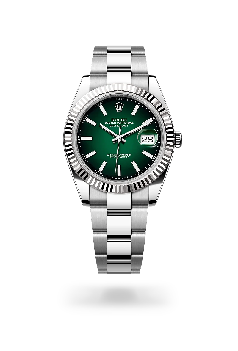 Rolex Oyster Perpetual Datejust watch with a green dial, fluted bezel, and stainless steel bracelet showing the date at 3 o'clock. | Brela