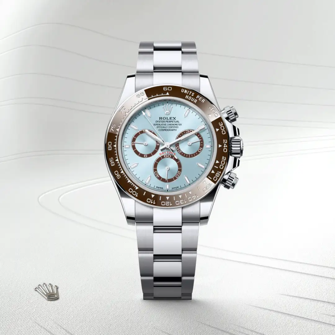 m126506-0001-slide1 | Brela Rolex Oyster Perpetual Cosmograph Daytona watch with light blue dial and brown bezel on a steel bracelet, angled to showcase detail. | Brela