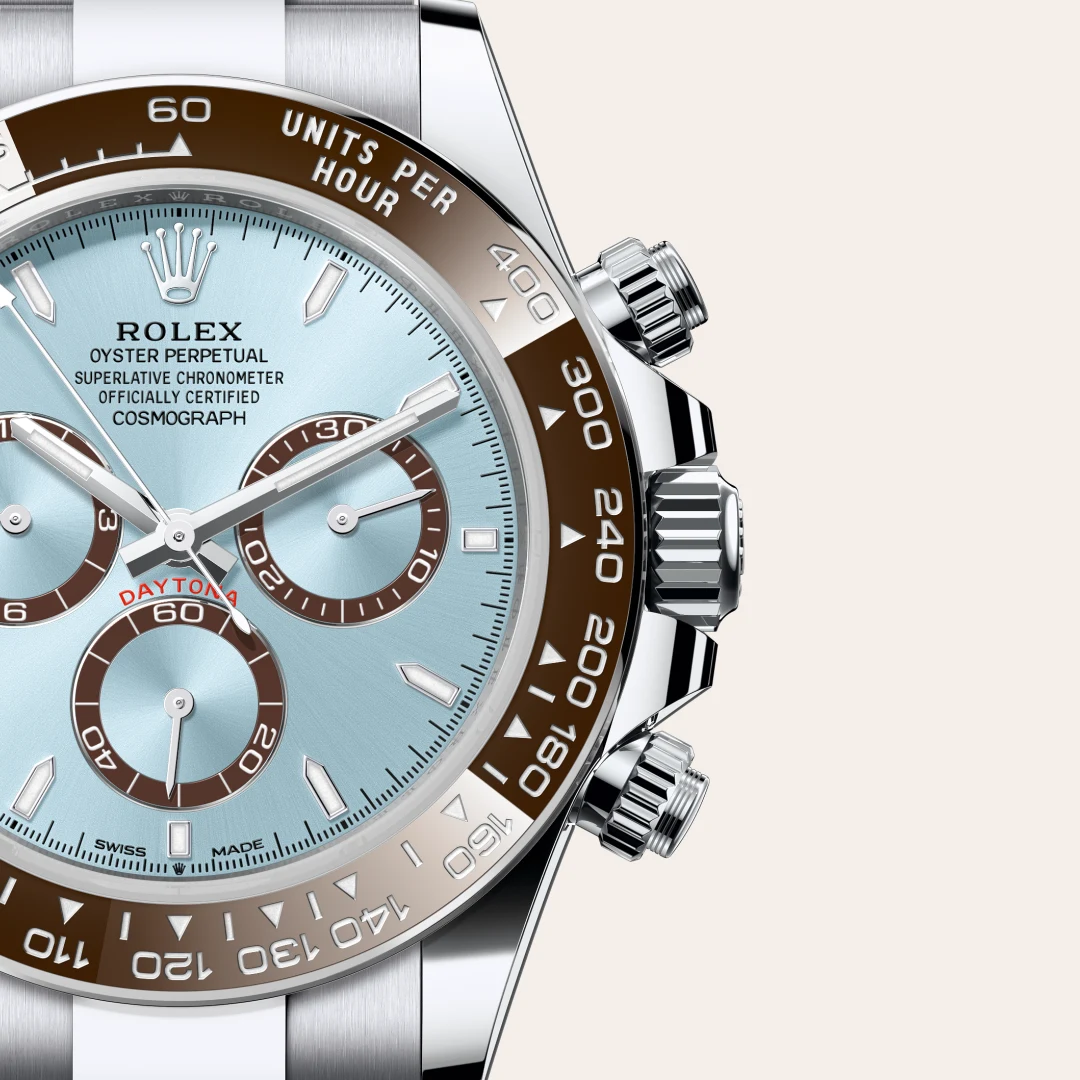 m126506-0001-slide3 | Brela Close-up of a Rolex Daytona chronograph with light blue dial, brown tachymeter bezel, and polished case. | Brela