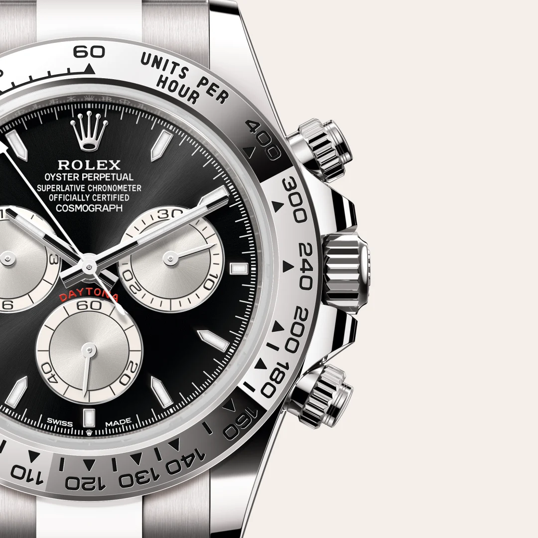 m126509-0001-slide3 | Brela Close-up of a stainless steel Rolex Daytona chronograph watch with a black dial and silver subdials, featuring a tachymeter bezel. | Brela