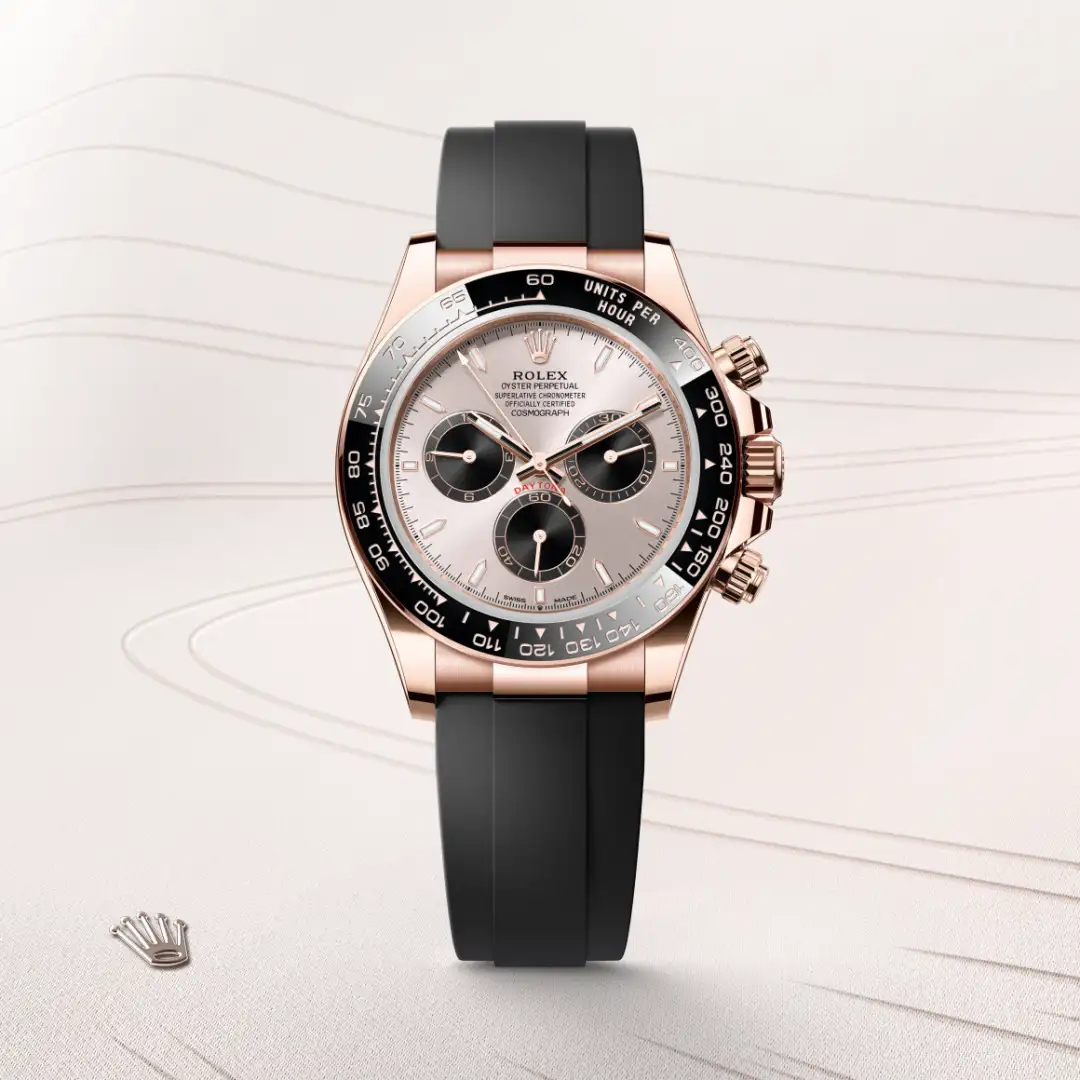 Rose gold Rolex Daytona watch with a black rubber strap and a silver dial featuring three subdials (chronograph) | Brela
