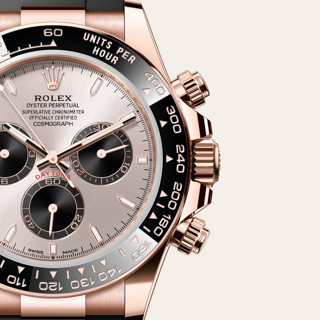 Close-up of a rose-gold Rolex Daytona watch showing the dial, subdials, and tachymeter bezel with 'ROLEX' branding. | Brela