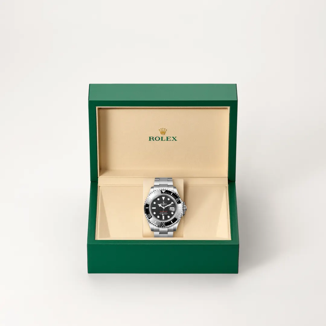 m126600-0002-slide2 | Brela Rolex wristwatch in an open green presentation box with a beige interior and black dial. | Brela