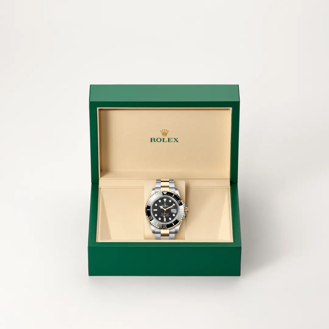 m126603-0001-slide2 | Brela Two-tone Rolex watch with black dial in an open green presentation box with a beige interior | Brela