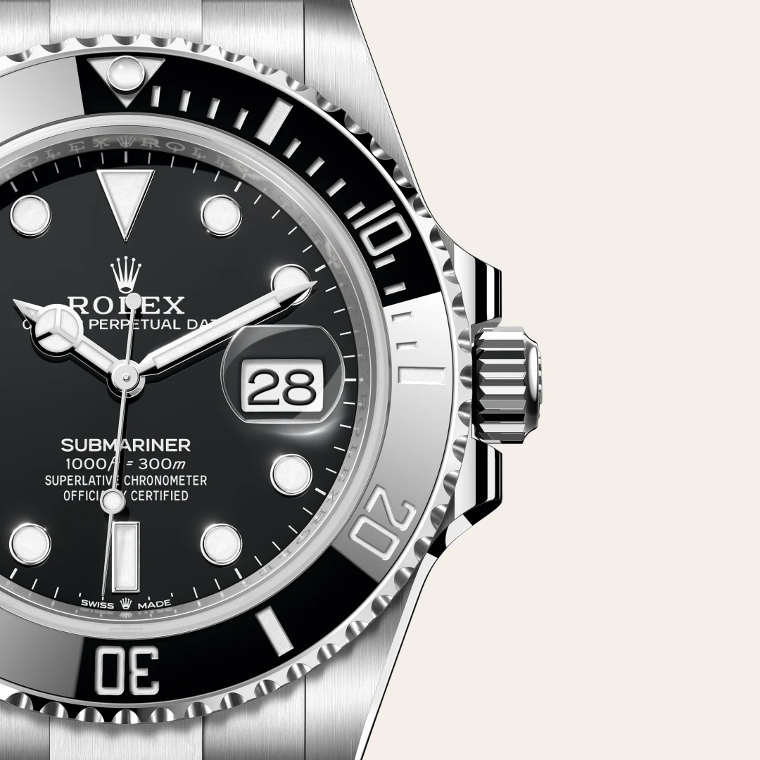m126610ln-0001-slide3 | Brela Close-up of a Rolex Submariner watch face, showing the date window at 3 o'clock and a stainless bezel. | Brela