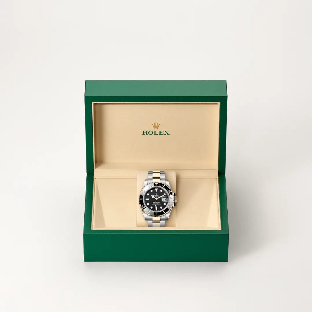 m126613ln-0002-slide2 | Brela Two-tone Rolex watch with black dial displayed in a green presentation box. | Brela
