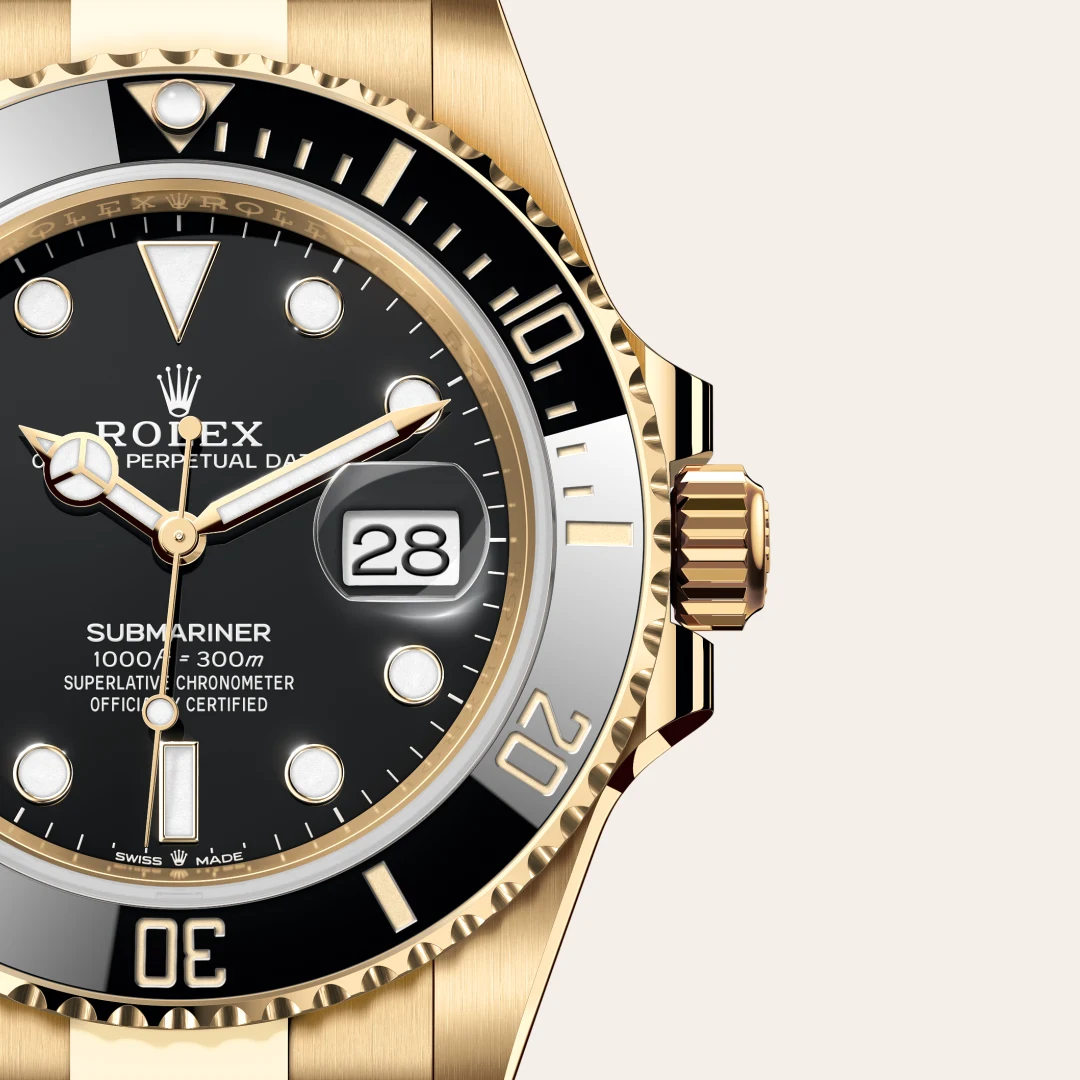 m126618ln-0002-slide3 | Brela Close-up of a gold Rolex Submariner watch with black dial, date window at 3 o'clock, and gold bezel. | Brela