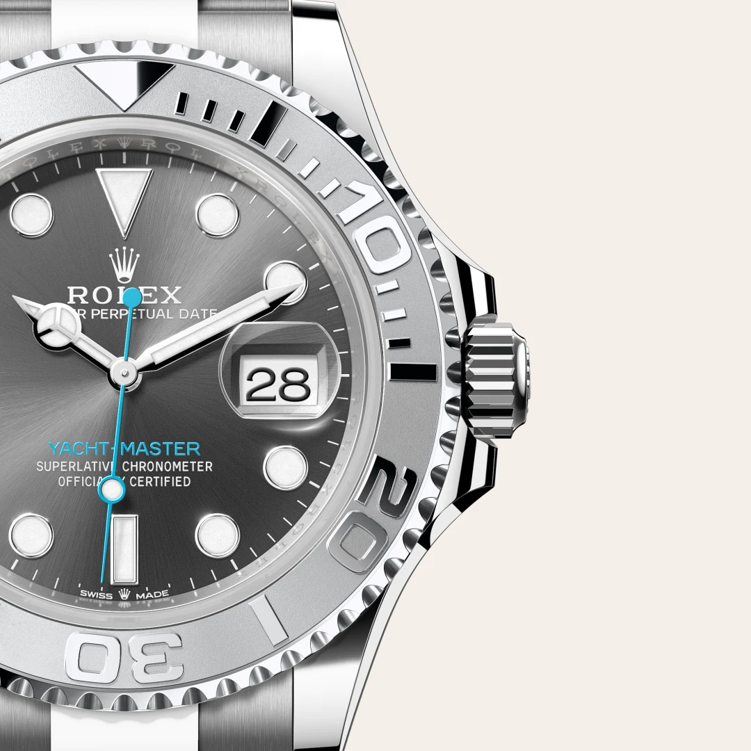m126622-0001-slide3 | Brela Close-up of a stainless steel Rolex Yacht-Master watch face with blue seconds hand, date window showing 28, and textured bezel. | Brela