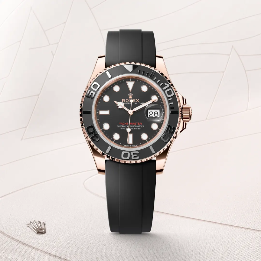 m126655-0002-slide1 | Brela Rolex Yacht-Master watch with a black dial, rose-gold case, and black rubber strap showing date at 3 o'clock. | Brela