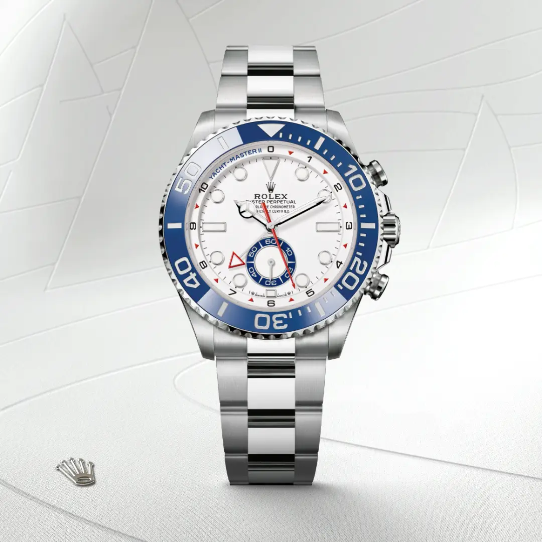 Rolex stainless steel wristwatch with white dial and blue bezel, shown against a light abstract background