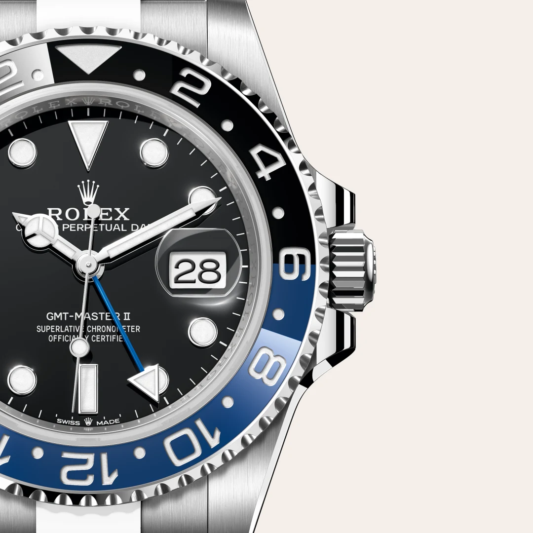 m126710blnr-0003-slide3 | Brela Close-up of a Rolex GMT-Master II wristwatch with a black dial, date window magnifier, and blue–black bezel. | Brela