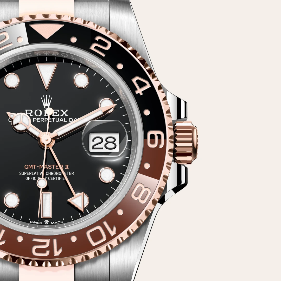 m126711chnr-0002-slide3 | Brela Close-up of a Rolex GMT‑Master II watch: black dial, rose‑gold bezel, magnified date window at 3, two-tone bracelet shimmers nearby | Brela