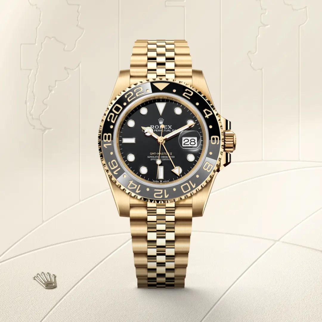 Gold Rolex GMT-Master II watch with black dial, gold bezel, and Jubilee bracelet showing date at 3 o'clock | Brela