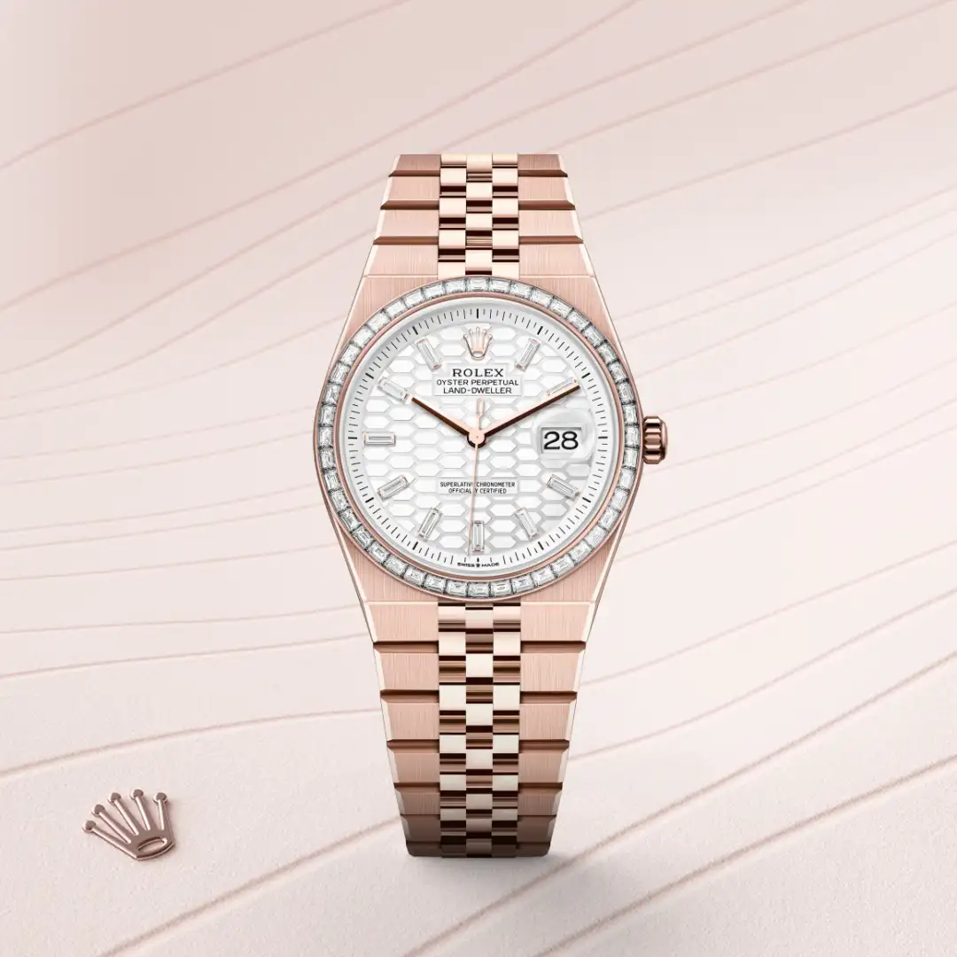 m127285tbr-0002-slide1 | Brela Rose gold Rolex watch with a diamond-set bezel, white patterned dial, and date window at 3 o'clock. | Brela