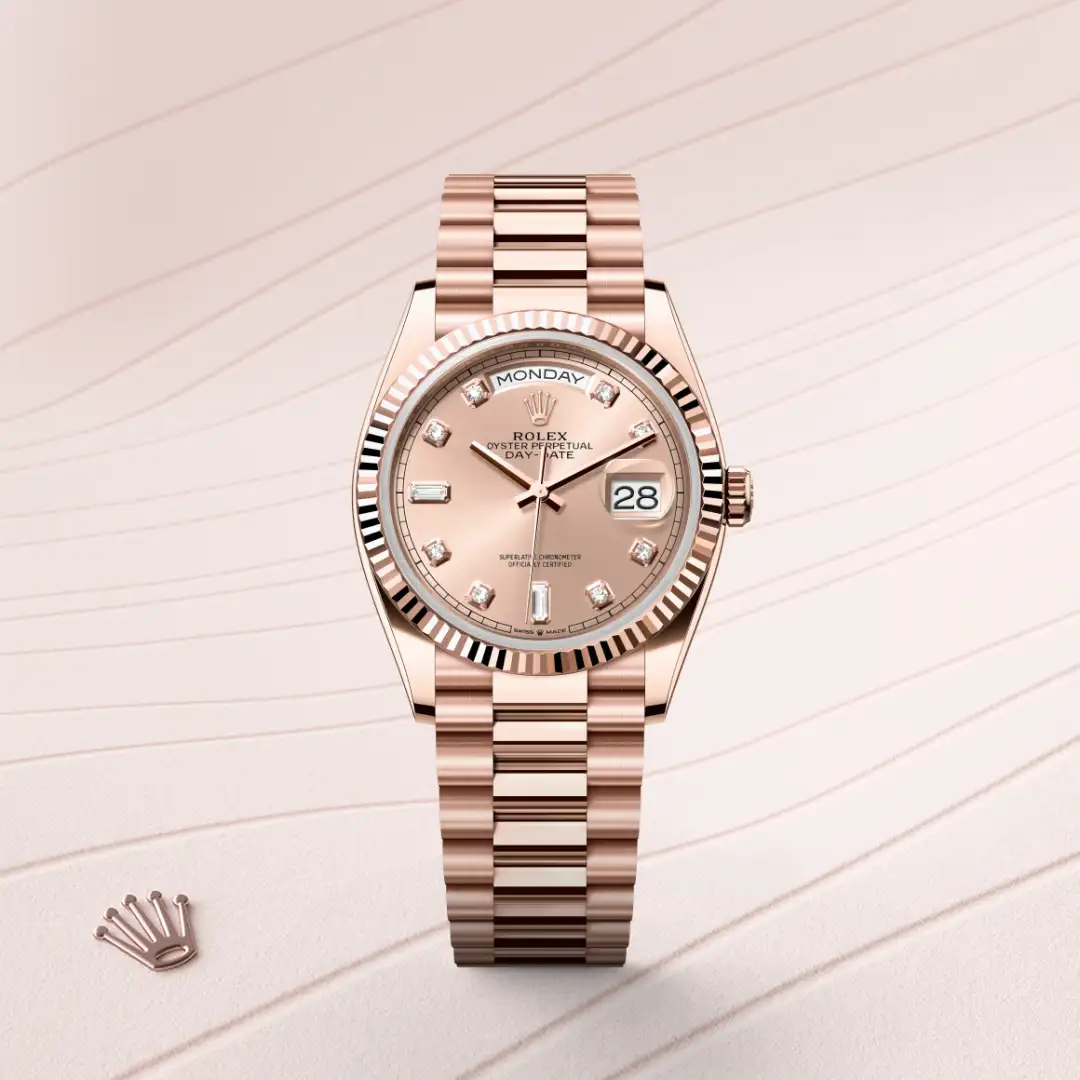 Rose gold Rolex Day-Date watch with a fluted bezel, diamond hour markers, and a date window at 3 o'clock on a peach dial. | Brela