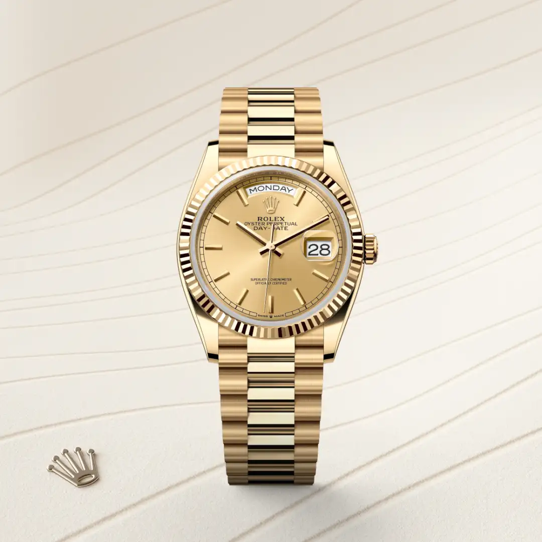 m128238-0045-slide1 | Brela Gold Rolex Oyster Perpetual Day-Date watch with fluted bezel and bracelet, displayed on a light striped background. | Brela