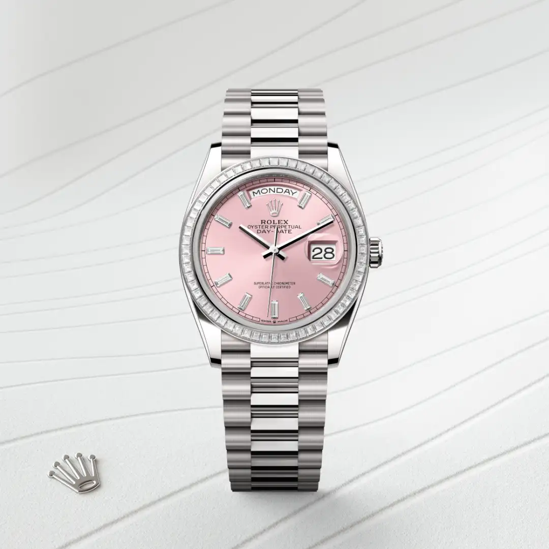 m128399tbr-0029-slide1 | Brela Rolex Day-Date wristwatch with pink dial, diamond bezel, and silver bracelet; day reads MONDAY and date shows 28. | Brela