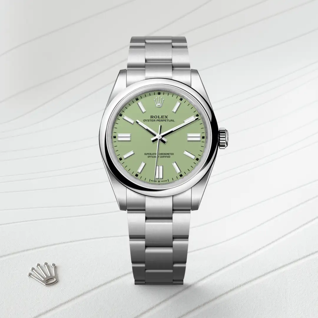 m134300-0006-slide1 | Brela Rolex Oyster Perpetual stainless steel watch with a mint-green dial on a light patterned surface, crown logo nearby. | Brela