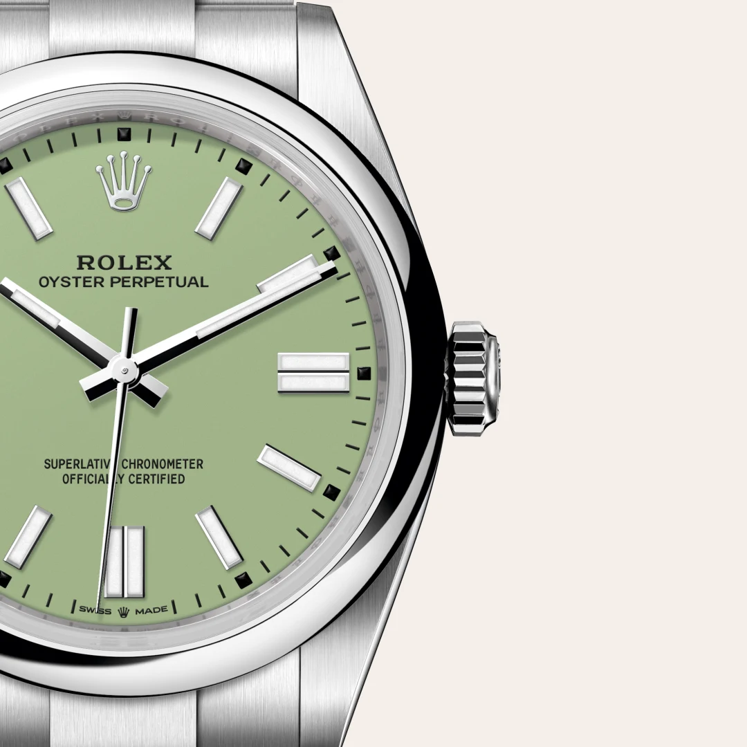 m134300-0006-slide3 | Brela Close-up of a Rolex Oyster Perpetual watch with a pale green dial, silver hands and markers, and a stainless steel case and bracelet. | Brela