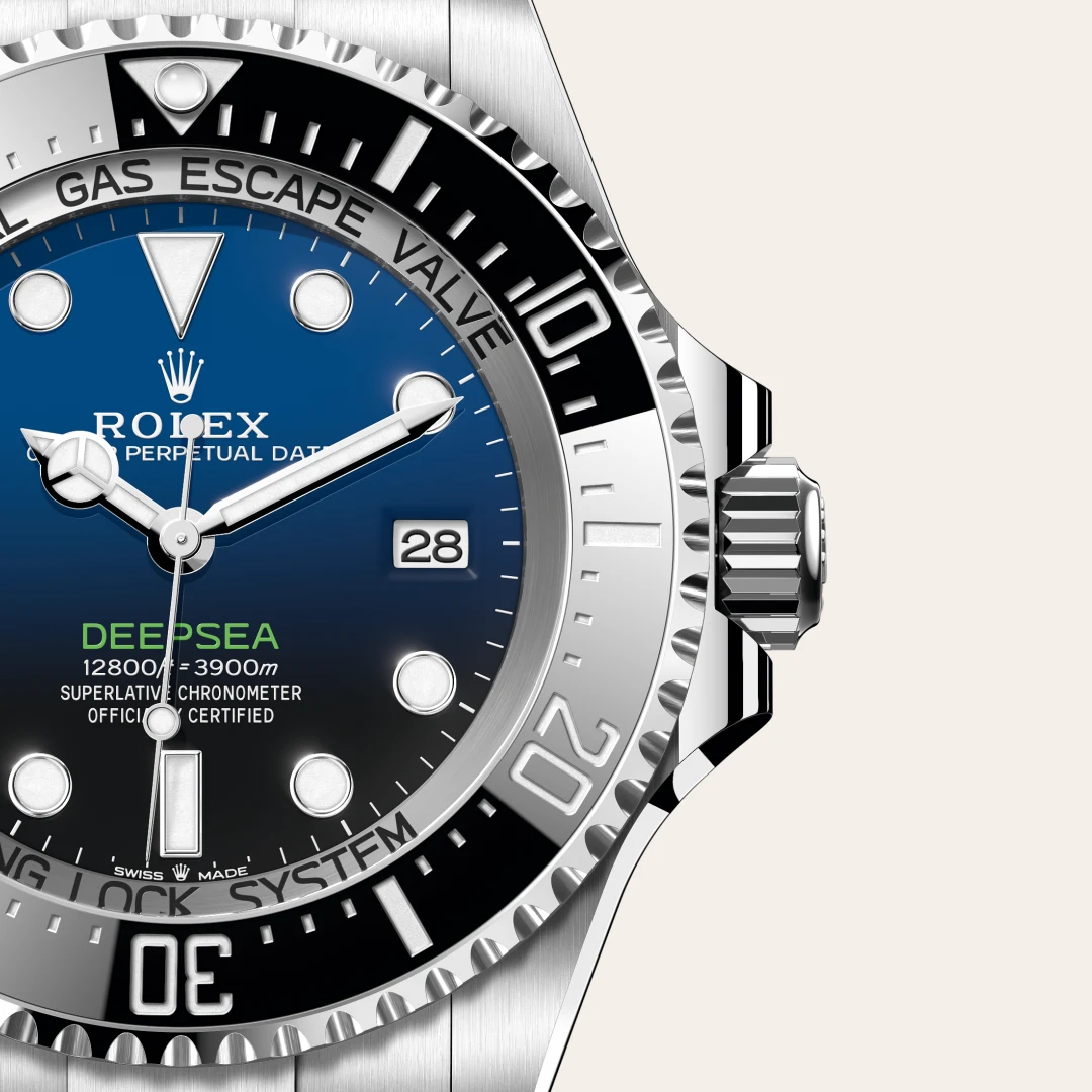 m136660-0005-slide3 | Brela Close-up of a Rolex Deepsea wristwatch with blue dial, date window at 3 o'clock, and a silver bezel and crown, highlighting its detail and finish. | Brela