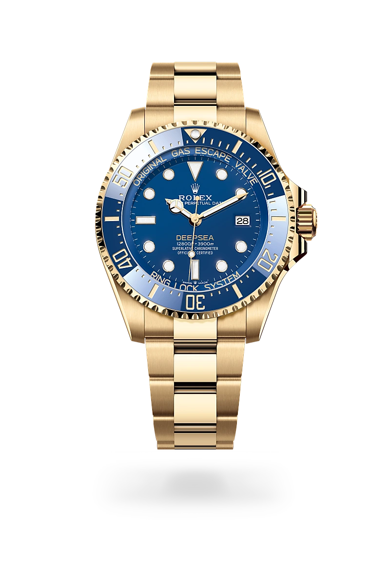 m136668lb-0001-upright-landscape | Brela Gold Rolex Deepsea diver's watch with a blue dial, rotating bezel, and date window at 3, shown on a black background with a polished gold bracelet. | Brela