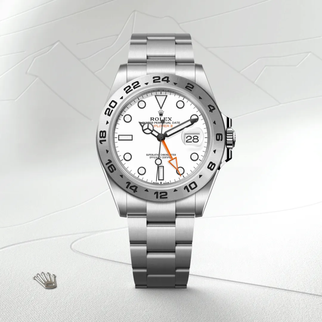 Rolex Explorer II: stainless steel watch with white dial, black hour markers, and orange GMT hand.