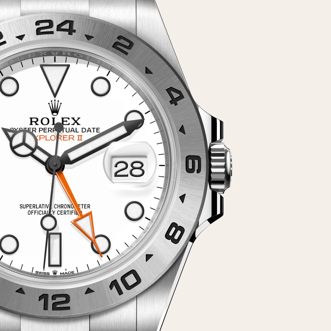 Close-up of a Rolex Oyster Perpetual Date Explorer II watch, white dial with orange 24-hour hand and date window showing 28.