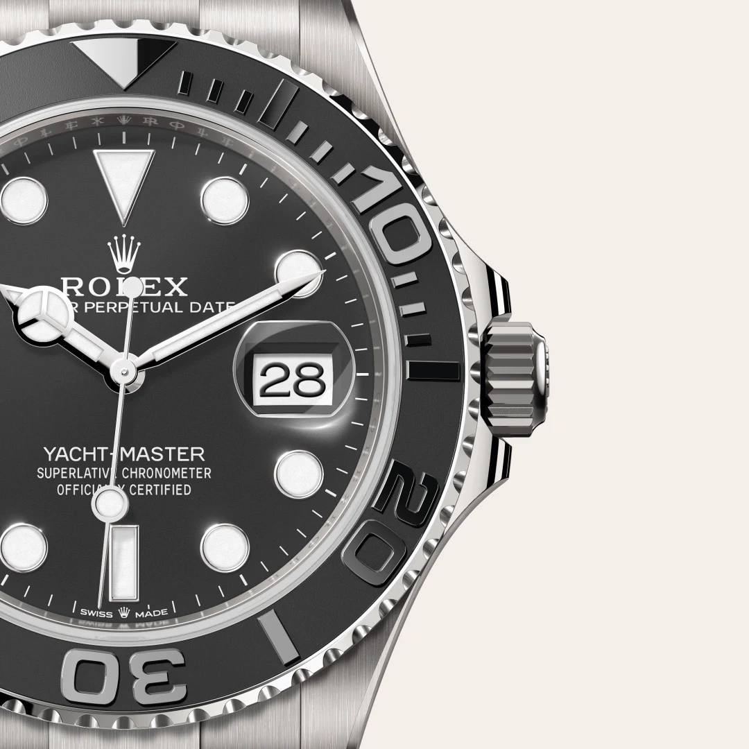 m226627-0001-slide3 | Brela Close-up of a Rolex Yacht-Master watch face with a date window showing 28 and a black dial | Brela