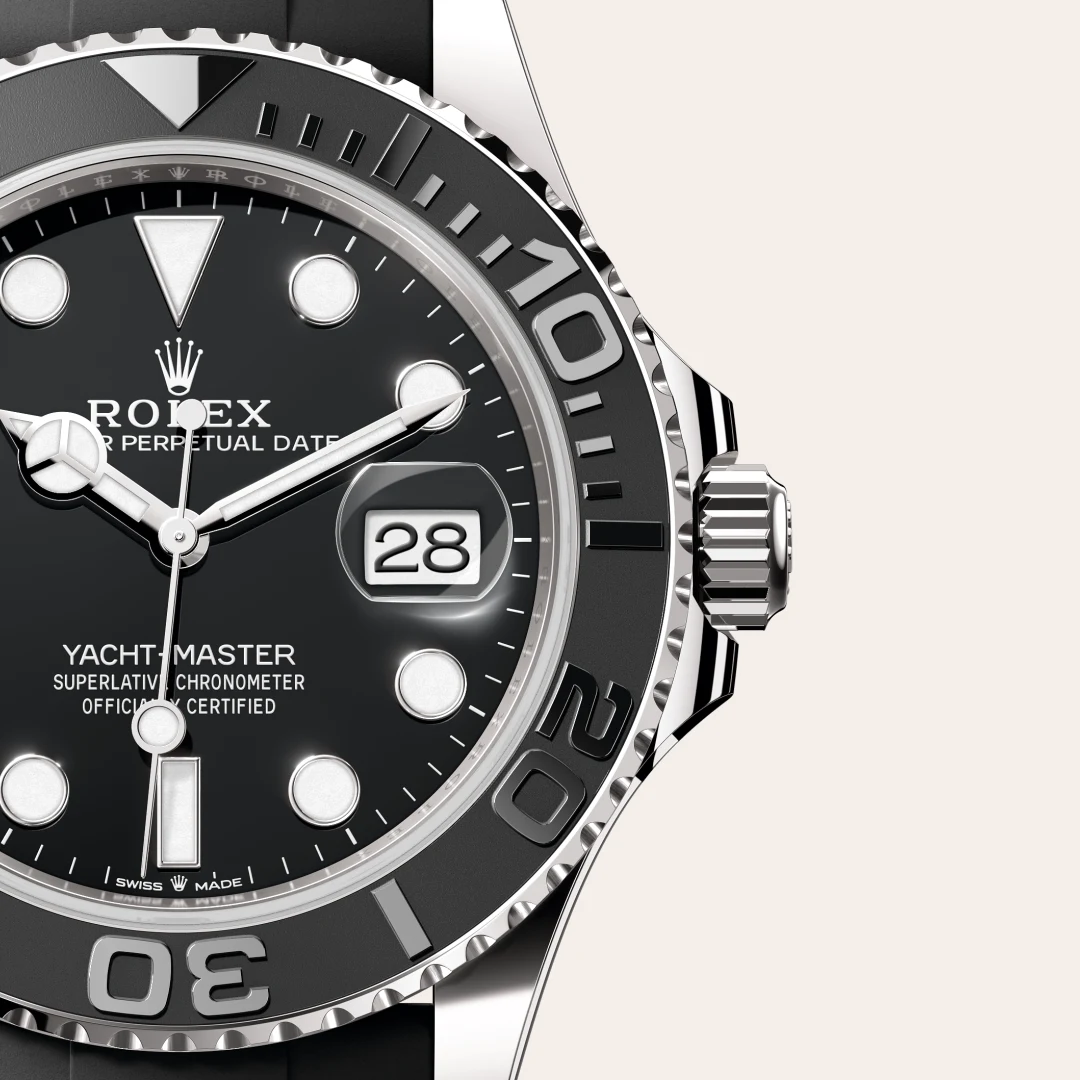 m226659-0002-slide3 | Brela Close-up of a Rolex Yacht-Master watch face with date window at 3 o'clock and black dial, silver hands, and bezel markings. | Brela