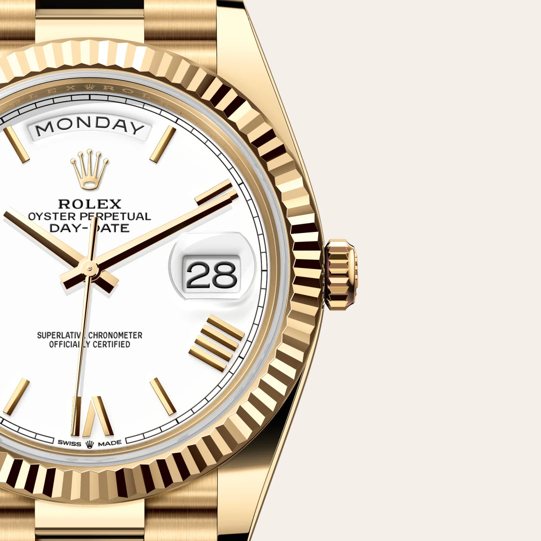 Gold Rolex Day-Date watch with white dial, day window showing 'MONDAY', and date 28 at 3 o'clock with fluted bezel. | Brela