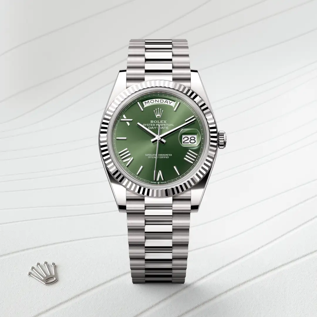 m228239-0033-slide1 | Brela Rolex Day-Date watch with a green dial, fluted bezel, and stainless steel bracelet showing Monday and the date 28. | Brela