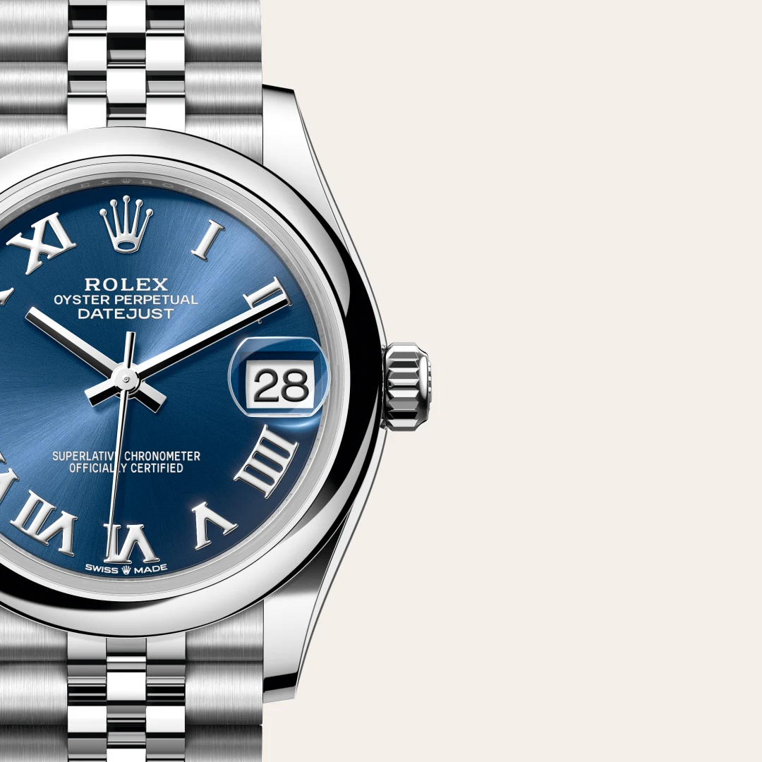 Close-up of a stainless steel Rolex Oyster Perpetual Datejust watch with a blue sunburst dial, Roman numerals, and a date window showing 28. | Brela