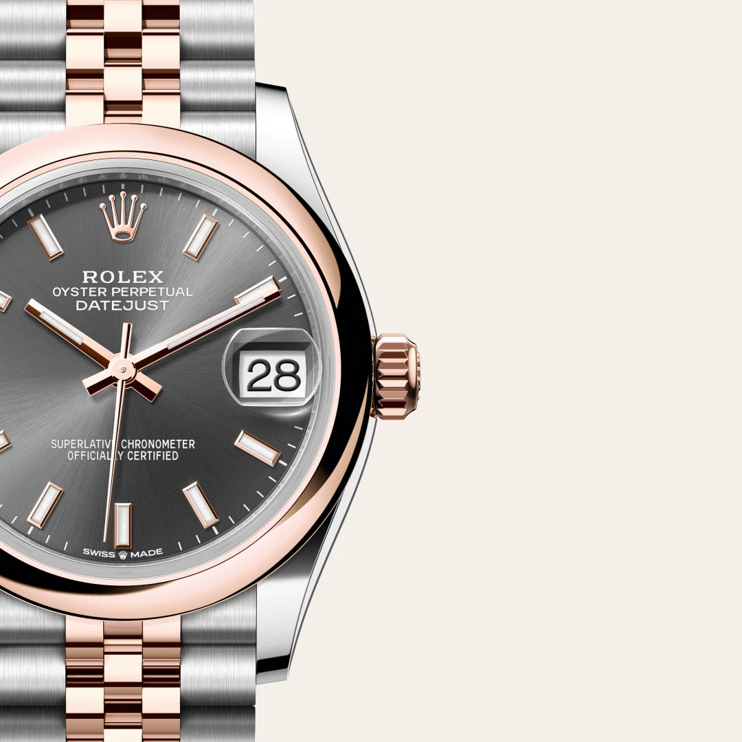 Close-up of a two-tone Rolex Datejust watch with grey dial, rose-gold bezel and bracelet, date window at 3 o'clock | Brela