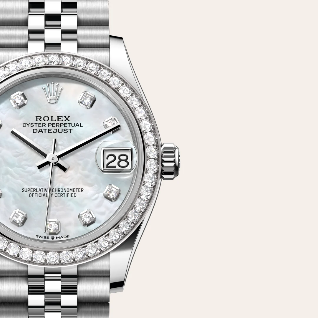 Close-up of a Rolex Oyster Perpetual Datejust watch with a diamond-encrusted bezel, mother-of-pearl dial, date window showing 28, and a metal bracelet .2E0f2f3f7d? | Brela