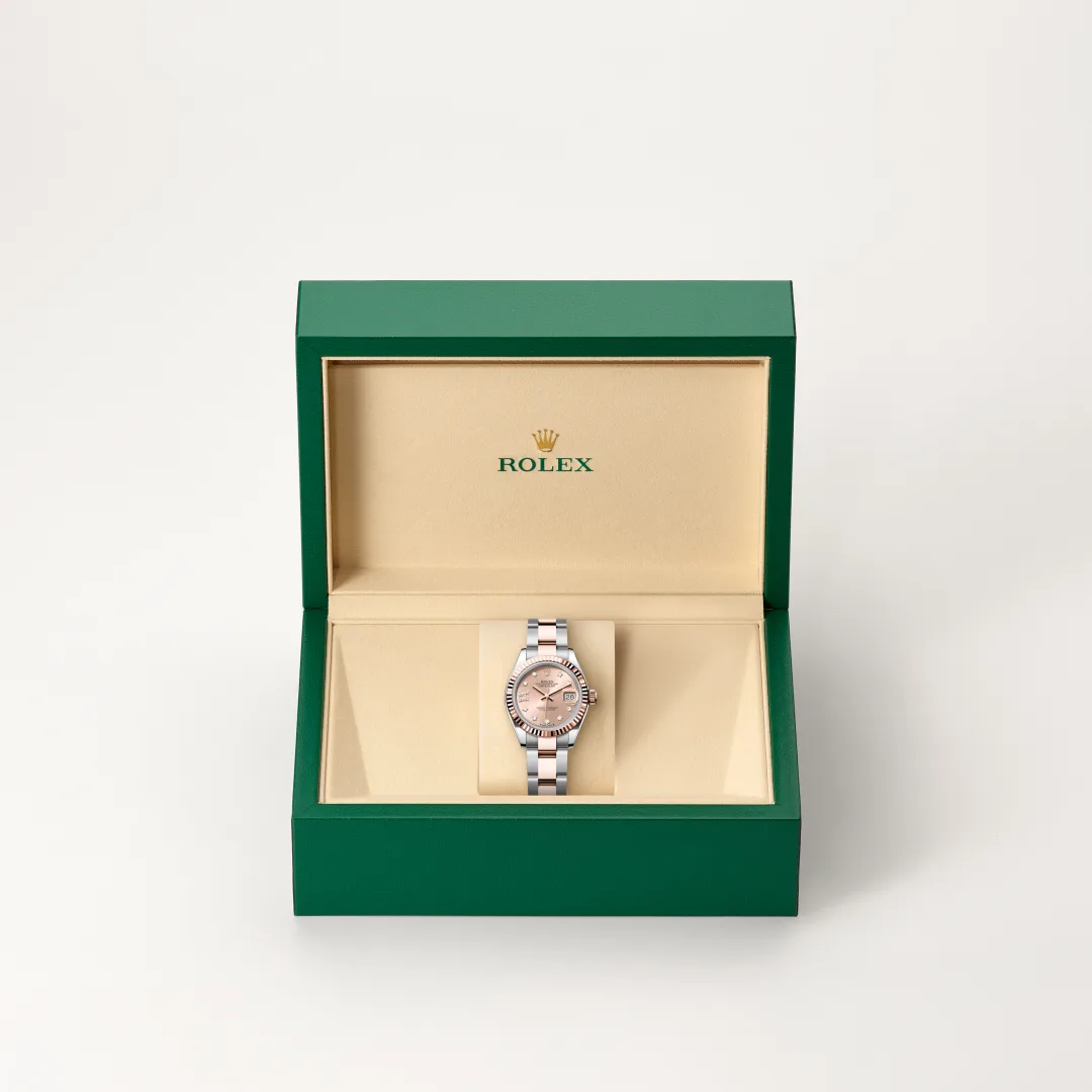 Rolex wristwatch with a two-tone bracelet inside a green presentation box with a beige interior. | Brela