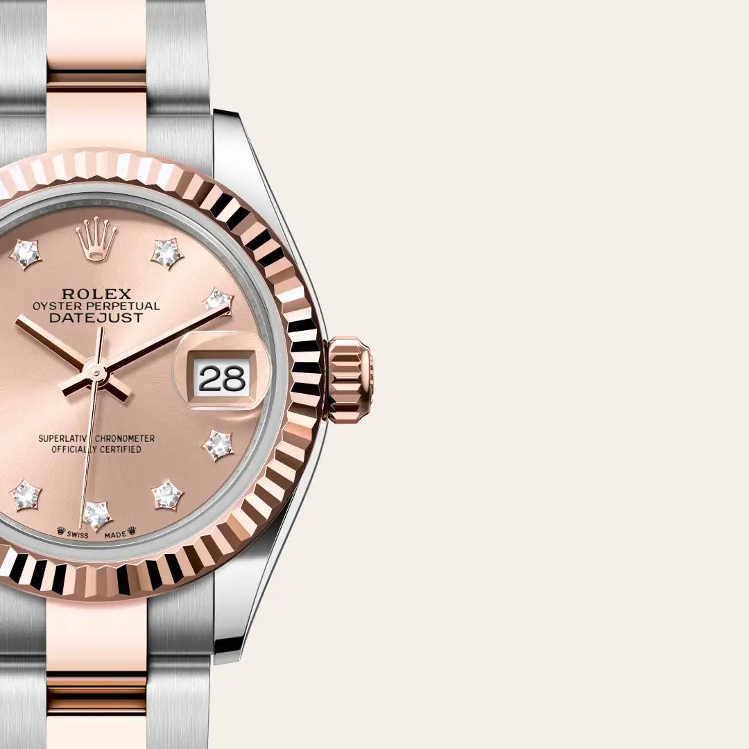 Close-up of Rolex Datejust watch with rose gold dial, diamond hour markers, and date at 3 o'clock. | Brela