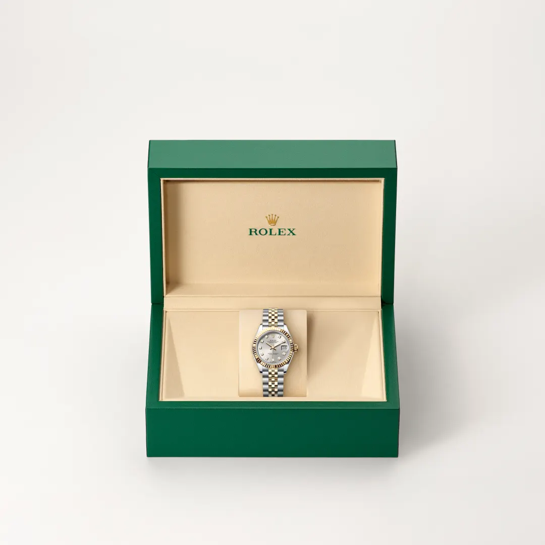 m279173-0007-slide2 | Brela Rolex watch in an open green presentation box with beige interior, showing a two-tone bracelet and silver dial. | Brela
