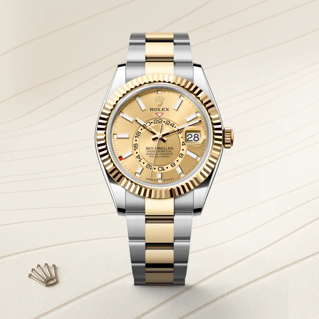 m336933-0001-slide1 | Brela Two-tone Rolex Sky-Dweller watch with a gold fluted bezel, silver and gold bracelet, beige dial, and date window at 3 o'clock on a light background. | Brela