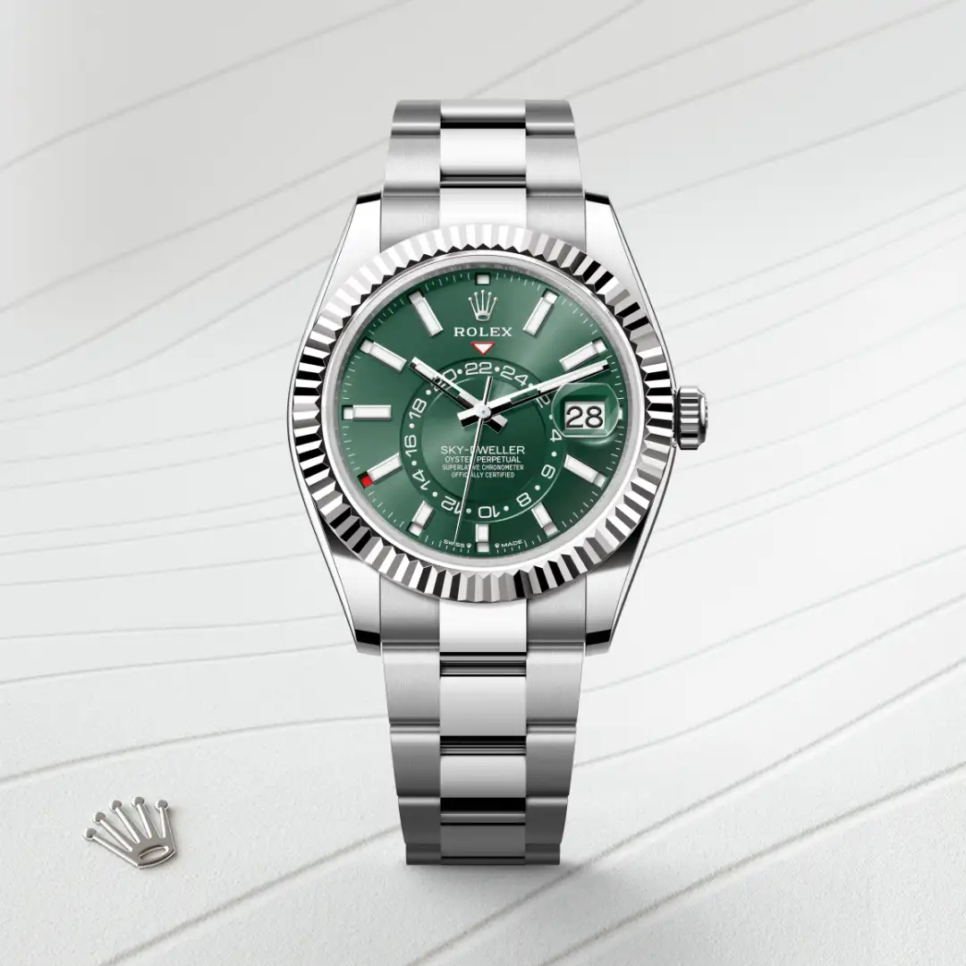 m336934-0001-slide1 | Brela Rolex Sky-Dweller stainless steel watch with a green dial, fluted bezel, date window at 3, and Oyster bracelet. | Brela