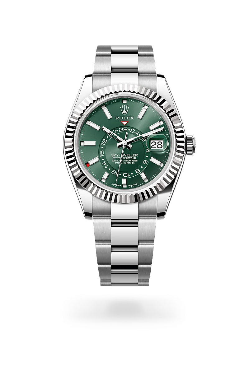 Rolex Sky-Dweller stainless steel watch with green dial and fluted bezel, date at 3 o'clock, bracelet visible | Brela