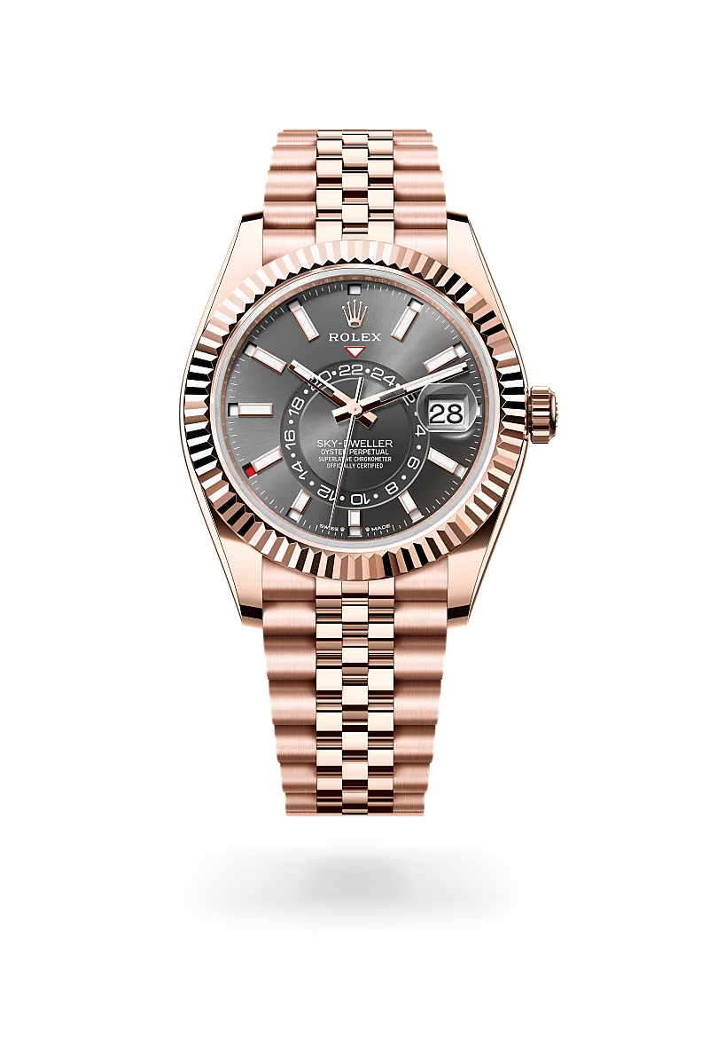 Rose gold Rolex Sky-Dweller watch with fluted bezel, gray dial, date window at 3, and Jubilee bracelet on black background | Brela