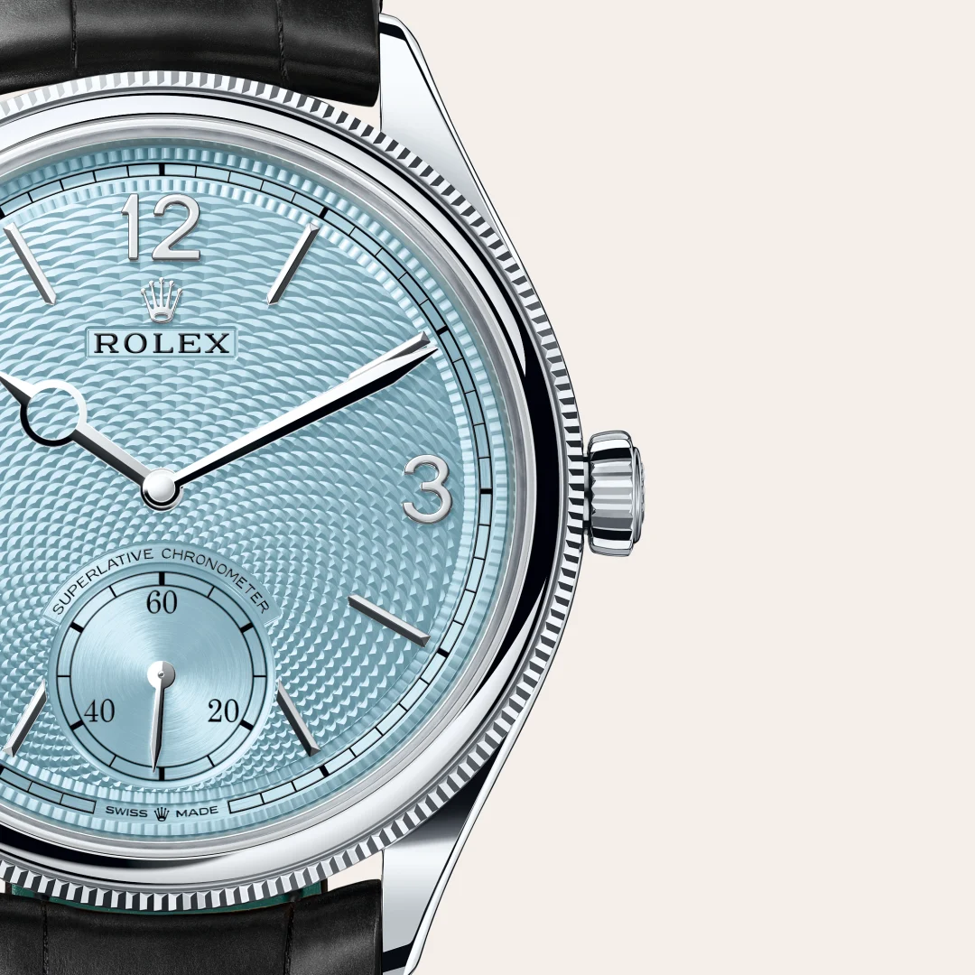 m52506-0003-slide3 | Brela Close-up of a Rolex wristwatch with a blue guilloché dial, silver indices, and a black leather strap. | Brela